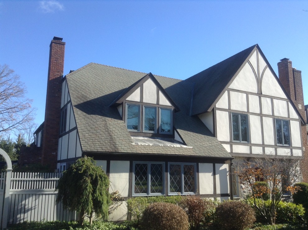 Tudor-style residence showcasing contrasting roof sections