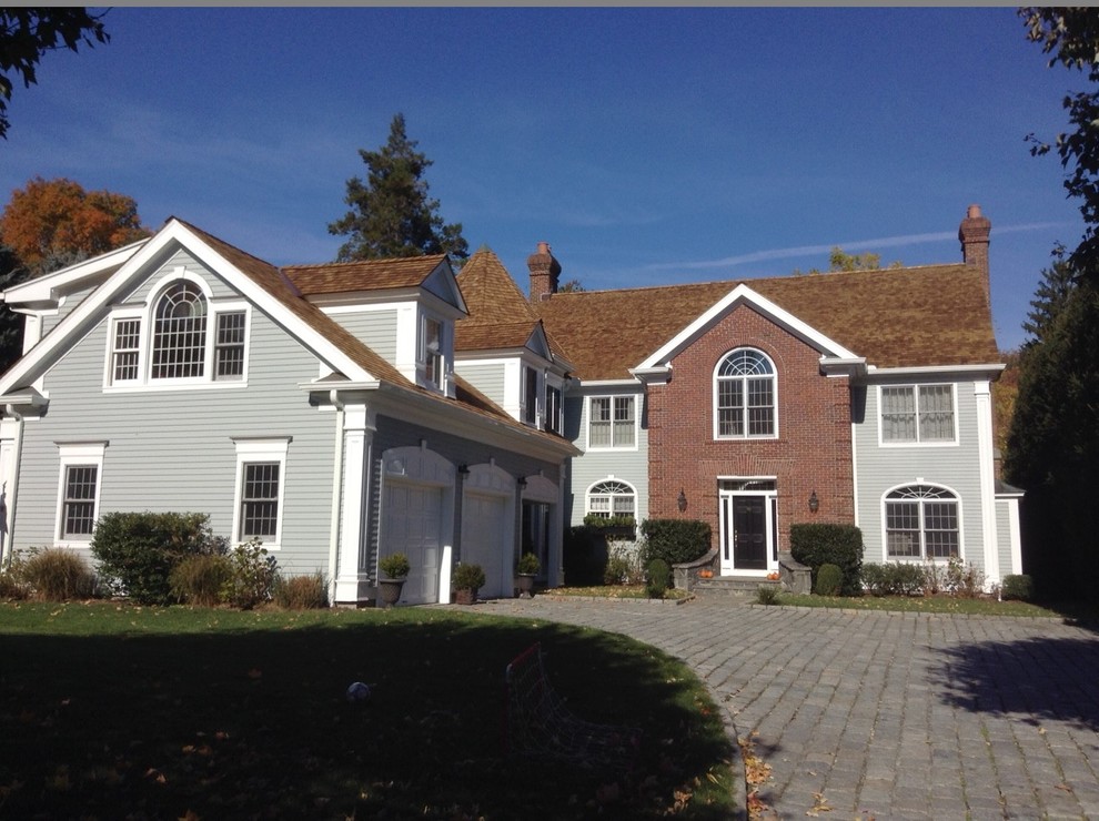 Large traditional residence with multiple cedar rooflines