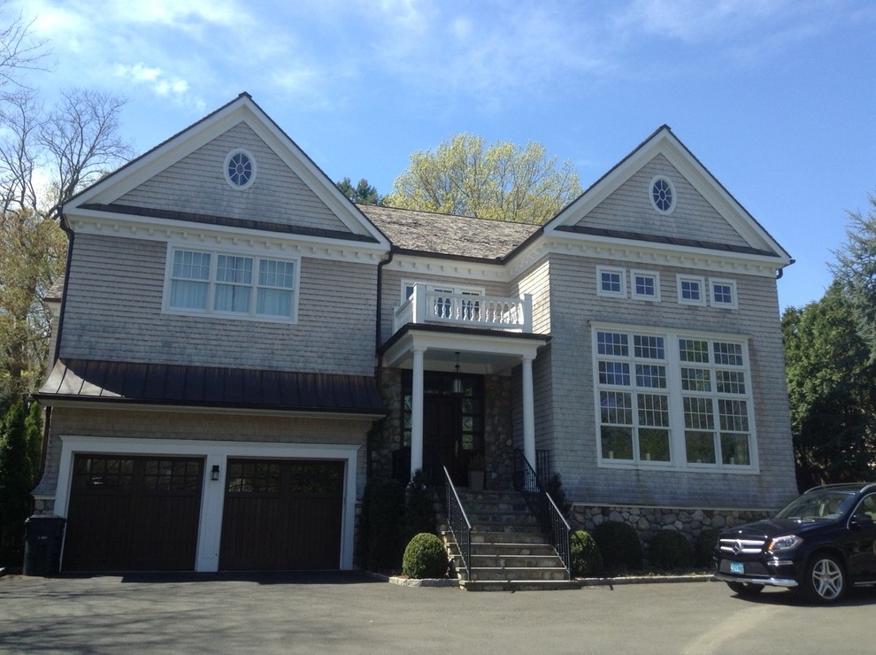 Front view of a gray residence with prominent sloped rooflines