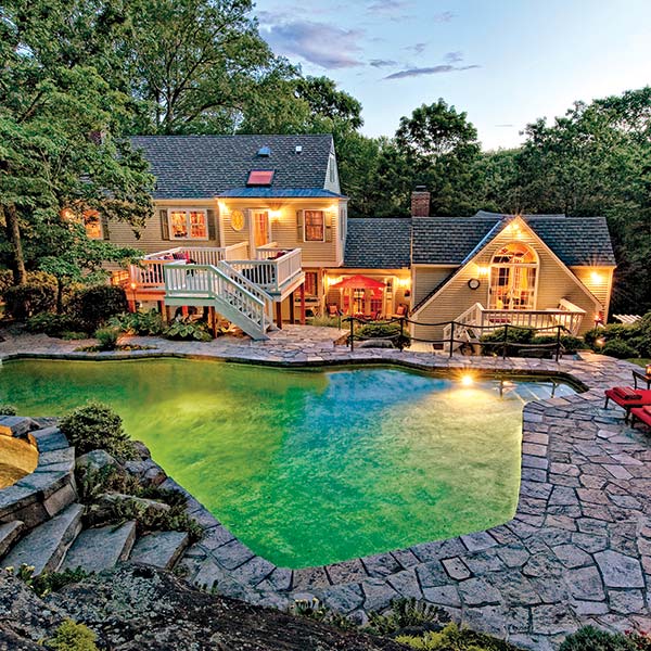 Rear exterior and pool area showcasing multiple completed roof sections
