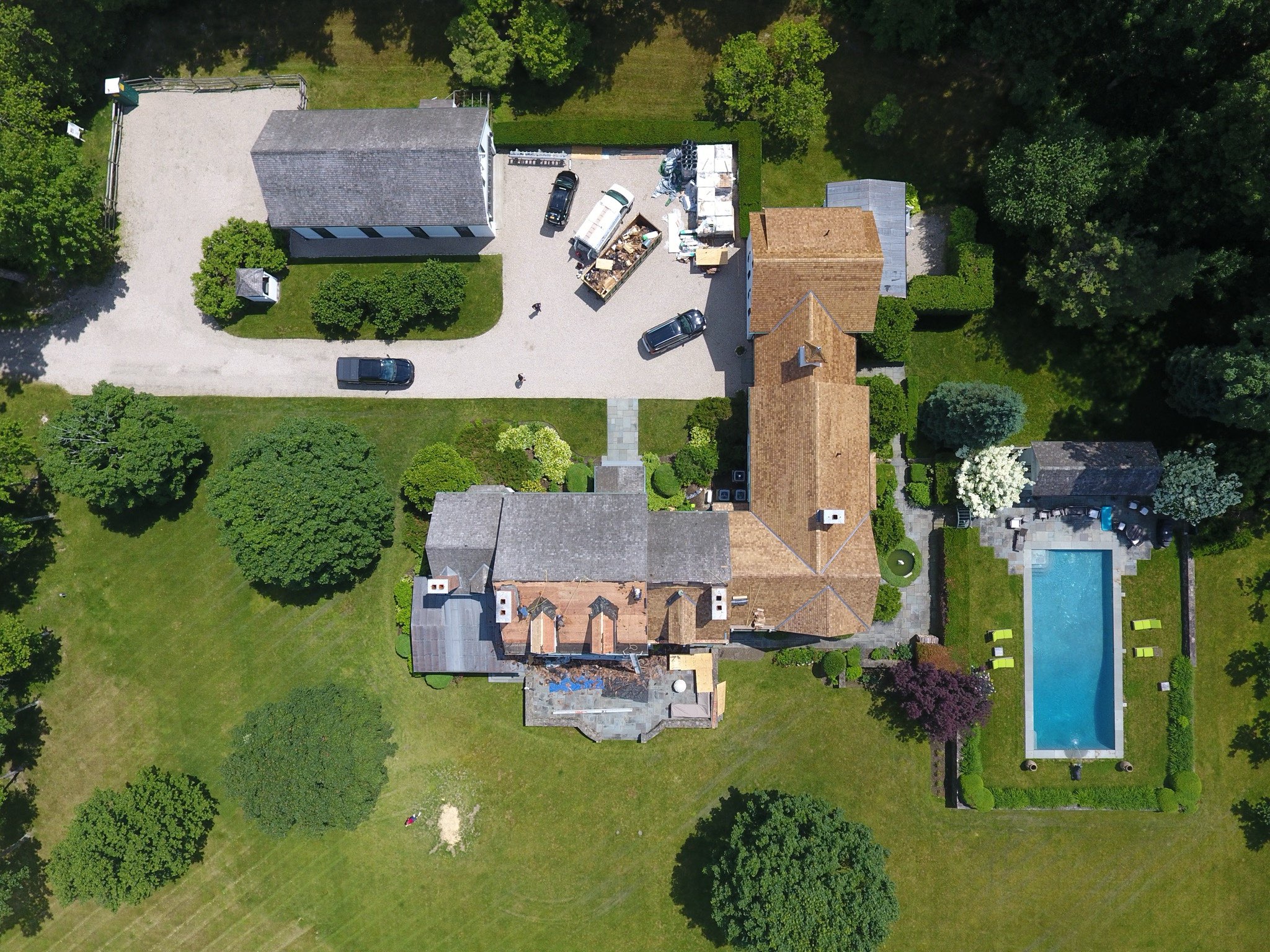 Top-down aerial view of a large residential roofing project in progress